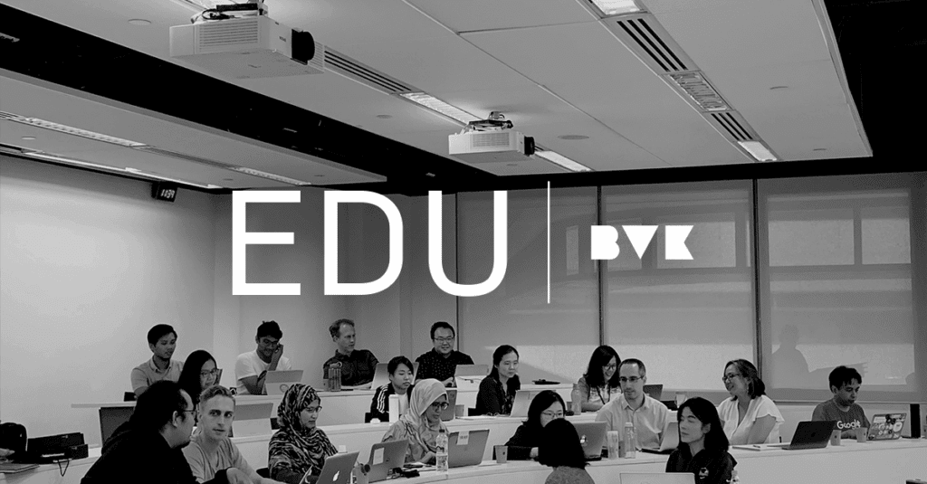 A black and white photo of students with laptops in a college lecture room with the caption "EDU BVK".