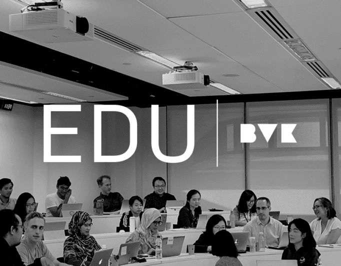 A black and white photo of students with laptops in a college lecture room with the caption "EDU BVK".