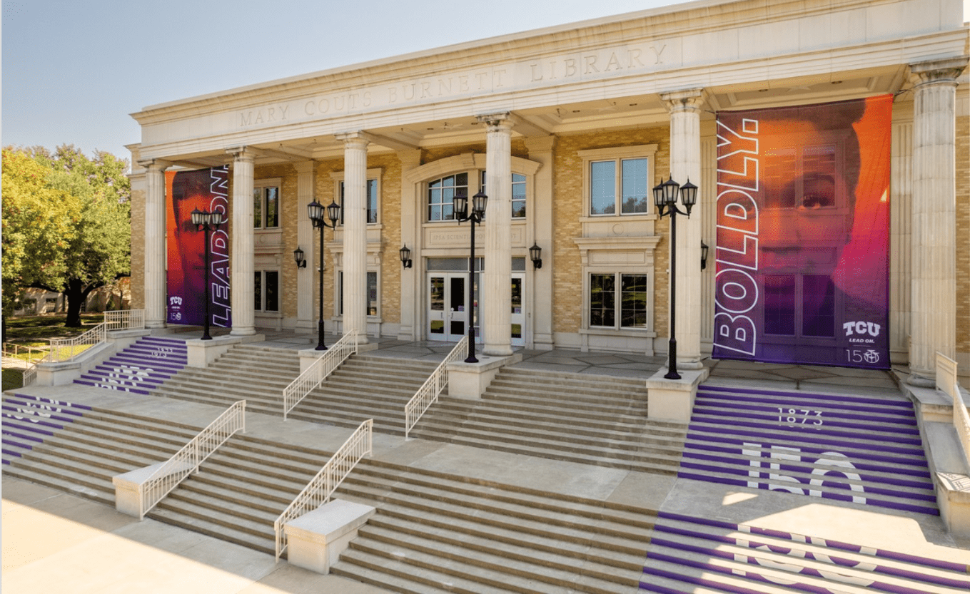 Banners on the side of a Texas Christian University building that read "Lean on. Boldly."