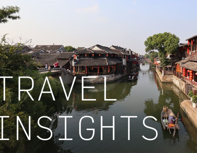 A gondola traveling down a canal in a Chinese city with the caption "Travel Insights".